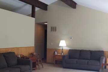 a living room filled with furniture and a flat screen tv