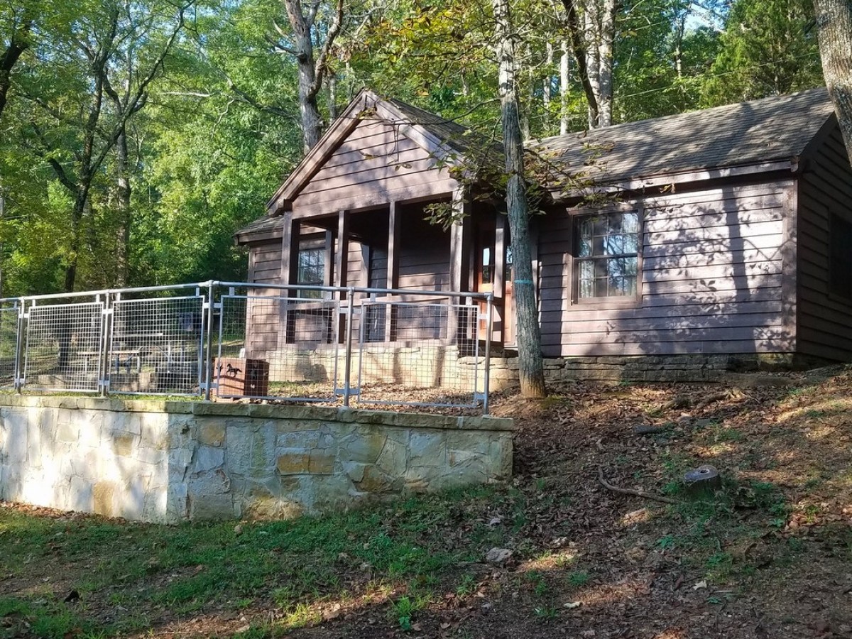 an old house with trees in the background