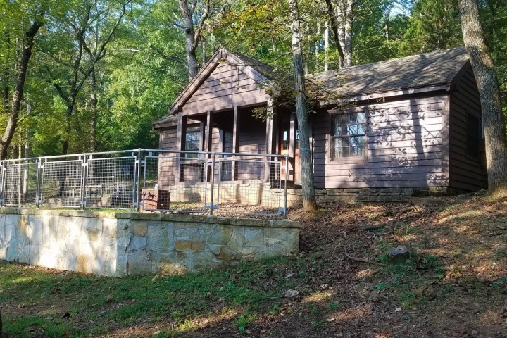 an old house with trees in the background