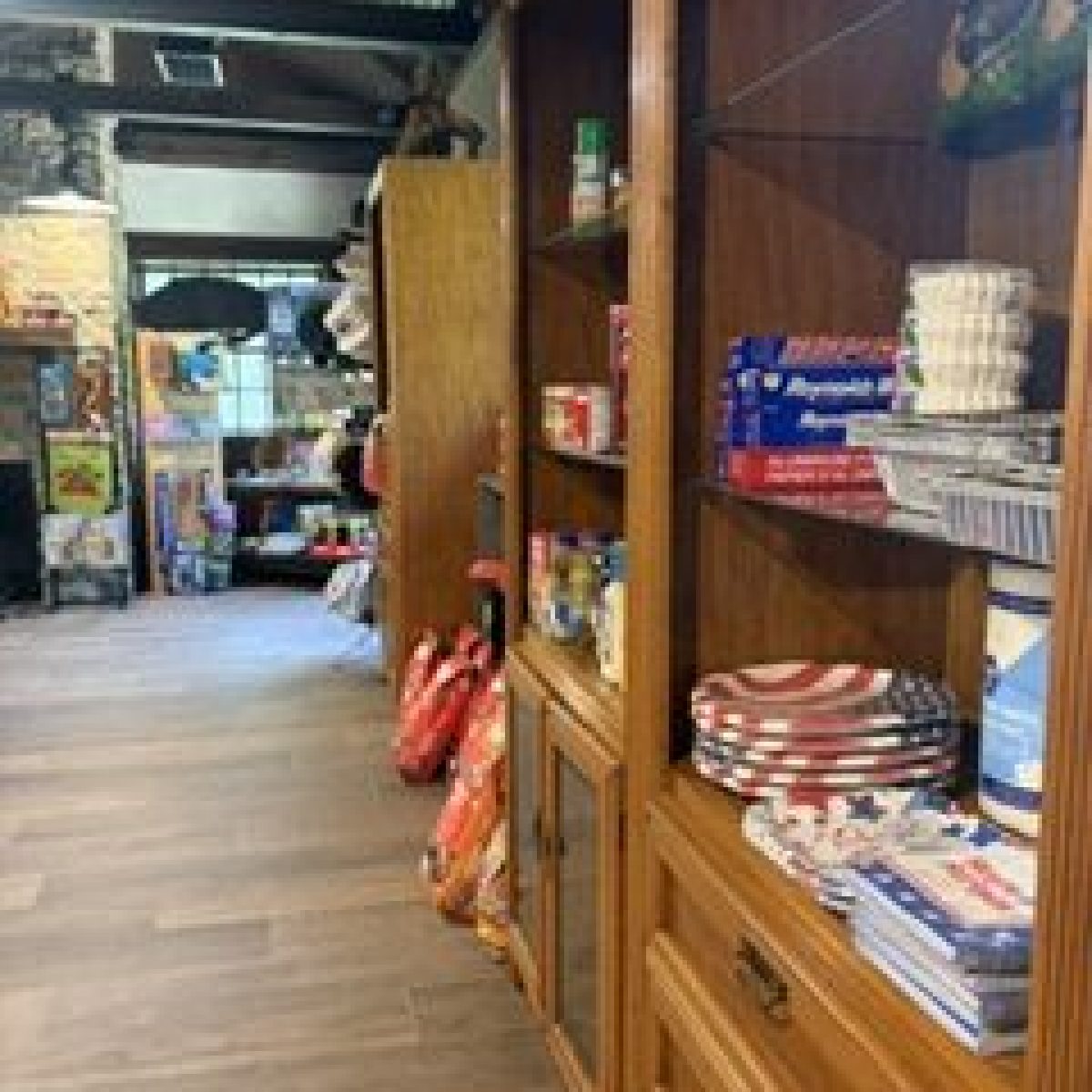 A pantry with shelves containing food and household items.