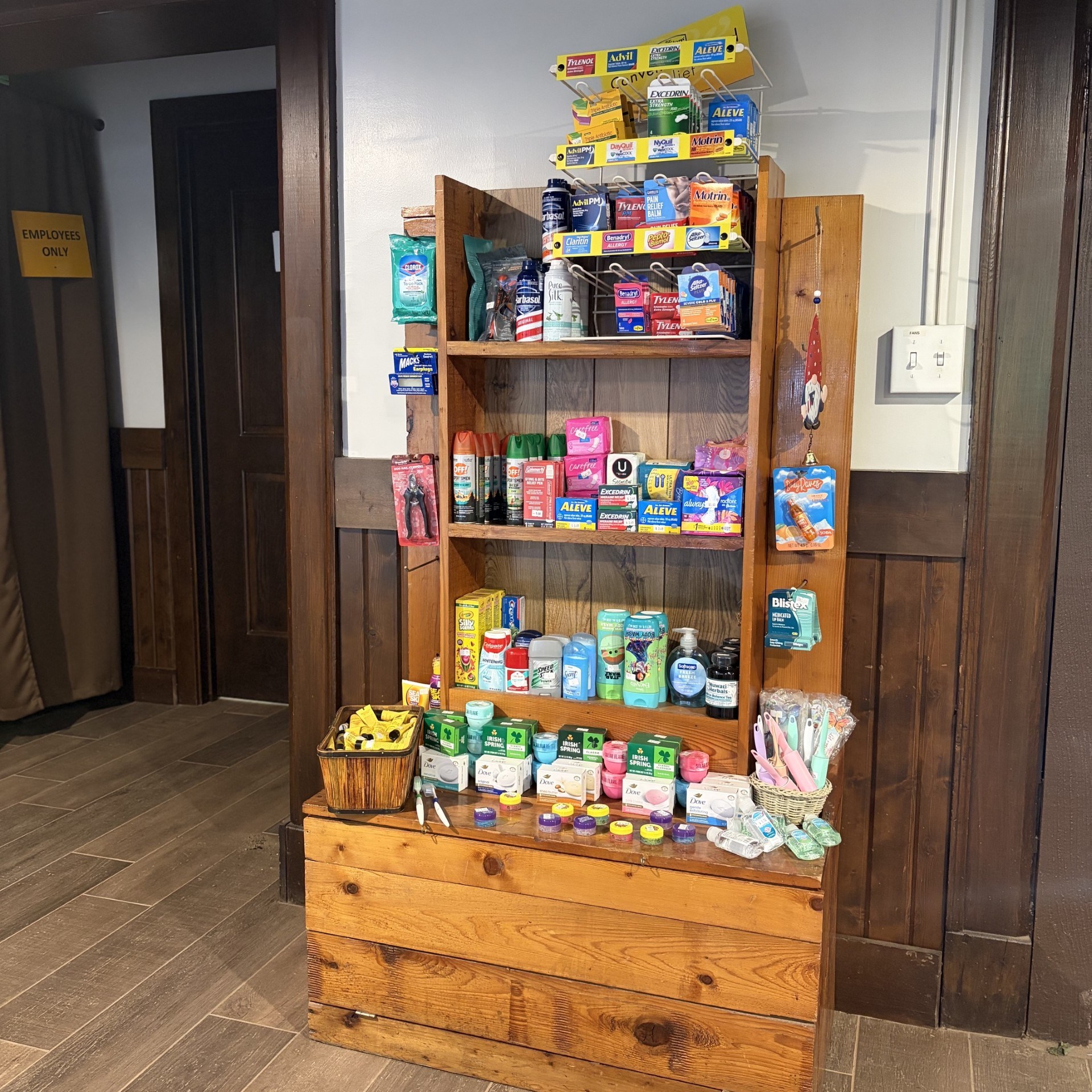 Wooden shelf with various toiletries and household items displayed.