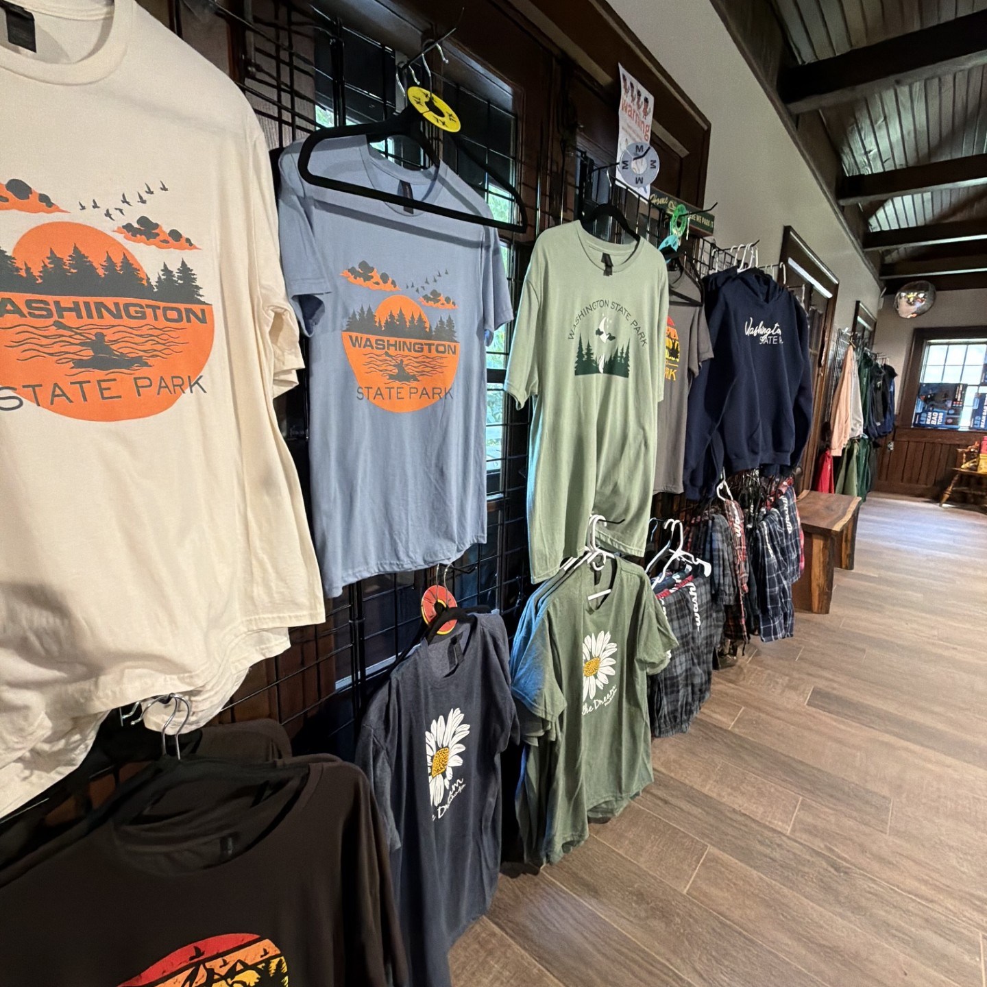 Display of state park shirts and clothing in a store.